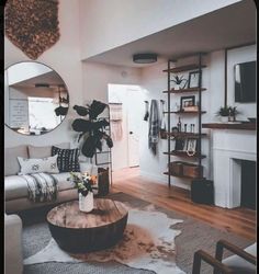 a living room filled with furniture and a large mirror on the wall over a fire place