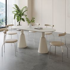 a white table with four chairs and a potted plant in the middle on top