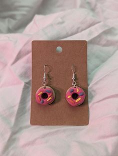 A dangle donut earring made from polymer clay Donut Earrings, Donuts Earrings, Donuts, Jewelry Earrings Dangle, Polymer Clay, Dangle Drop Earrings, Dangle Earrings, Jewelry Earrings, Drop Earrings