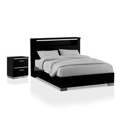 a black bed with two nightstands next to it