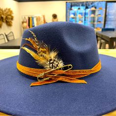 Beautiful Hat I Decorated. Very Unique. Blue Short Brim Felt Hat For Fall, Blue Felt Hat With Flat Brim For Spring, Blue Flat Brim Felt Hat For Spring, Blue Flat Brim Fedora For Winter, Blue Wide Brim Felt Hat For Fall, Blue Adjustable Fedora For Kentucky Derby, Blue Fedora With Short Brim For Fall, Fall Wide Brim Blue Felt Hat, Blue Flat Brim Fedora For Fall