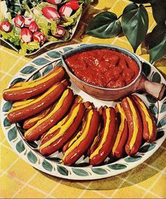 hotdogs with mustard and ketchup on a plate next to a salad