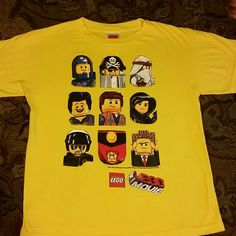 a yellow shirt with lego characters on it