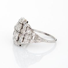 Elegant & finely detailed Art Deco era ring (circa 1920s to 1930s), crafted in 900 platinum.   Two centrally mounted estimated 0.20 carat (each) Old European cut diamonds are accented with an estimated 0.34 carats of single cut diamonds. The total diamond weight is estimated at 0.74 carats (estimated at I-J colour and VS2-SI1 clarity).     The ring epitomises vintage charm and would make a lovely alternative engagement ring. The stylized square mount reflects the clean lines and geometric forms Art Deco Platinum Diamond Ring With Brilliant Cut, Art Deco Platinum Diamond Ring With Vvs Clarity, Art Deco Oval Cluster Ring In Platinum, Art Deco Oval Platinum Diamond Ring, Art Deco Platinum Diamond Ring With Round Cut, Art Deco Oval Diamond Ring With Vvs Clarity, Platinum Art Deco Diamond Ring With Round Cut, Art Deco Platinum Diamond Ring In Diamond White, Art Deco Diamond White Cluster Ring In Platinum