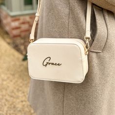 𝐌𝐚𝐤𝐞 𝐘𝐨𝐮𝐫 𝐌𝐚𝐫𝐤 Let our Personalised Script Name Faux Leather Handbag be the finishing touch to your look. It's the go-to for adding a personal twist to a sleek staple. 𝐂𝐫𝐚𝐟𝐭𝐞𝐝 𝐟𝐨𝐫 𝐘𝐨𝐮 Imagine your name in elegant 3D script on a handbag that feels as good as it looks--durable, yet with a touch of class that's unmistakably you. 𝐒𝐭𝐲𝐥𝐞 𝐟𝐨𝐫 𝐄𝐯𝐞𝐫𝐲 𝐒𝐜𝐞𝐧𝐞 Dress it up or down, this handbag swings both ways. It's your trusty sidekick for a day in town or that spe Personalized Pouch Bag For Everyday Use, Cream Mobile Phone Bag As Gift, Cream Shoulder Bag With Adjustable Strap As Gift, Cream Bag With Detachable Strap For Gift, Personalized Gift White Bag, Elegant Rectangular Bag For Personalized Gift, Personalized Shoulder Bag For Daily Use, Elegant Rectangular Bag As Personalized Gift, Elegant Rectangular Bags For Personalized Gifts