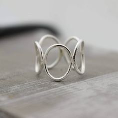 Sterling Silver Open Circle Ring Band - Bubble Ring - Midi Ring This simple sterling circle ring is a great addition to your wardrobe. It is a nice simple modern looking silver ring and so comfortable to wear. I start by making circles and then solder them together and form it into a ring, I then tumble it for hours to a beautiful shine. Each ring will be made to order in your size, please allow 5-7 business days for your ring to be made. Open Circle Ring, Modern Silver Jewelry, Silver Ring Band, Bubble Ring, Handmade Sterling Silver Rings, Circle Ring, Popular Jewelry, Yoga Jewelry, Silver Jewelry Rings