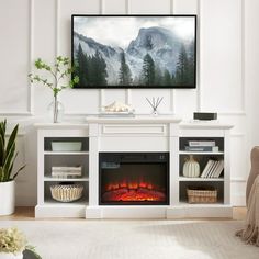 a flat screen tv mounted above a fire place in a living room with white walls