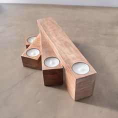 three wooden candles sitting on top of each other