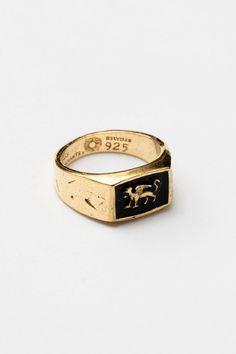 "Introducing the \"Gryphon\" Gold Signet Ring by Merchants of the Sun: a captivating and unisex piece of handmade jewelry. Crafted in 18k gold vermeil, this minimalist ring features a striking gryphon design with black enamel detailing. With its meticulous craftsmanship and timeless appeal, the \"Gryphon\" ring from Merchants of the Sun is a perfect gift for men seeking a unique and meaningful accessory. Known as a guardian of treasure and a mouthpiece for the sun, the Gryphon epitomises a level Antique Signet Ring With Black Enamel For Gift, Antique Black Enamel Signet Ring As Gift, Gold Enamel Ring With Black Detail For Formal Occasions, Antique Yellow Gold Signet Ring With Black Enamel, Classic Gold Enamel Signet Ring, Luxury Gold Enamel Ring For Ceremonial Occasions, Heirloom Style Signet Ring With Black Enamel As Gift, Gold Rings With Black Enamel For Gifts, Ceremonial Gold Jewelry With Black Enamel