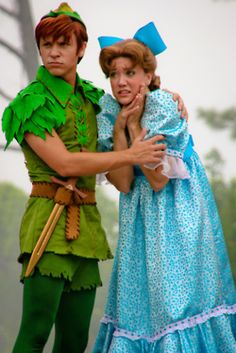 two people dressed as peter panton and tinkerbell, one holding the other