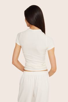 Discover sleek style with the Ribbed Modal Body Tee in Blanc. This full-length short sleeve fitted t-shirt features binding around the neckline, crafted from luxurious ribbed modal fabric. Modal Fabric, Sweat Top, Sleek Style, Skirt Jumpsuit, Swim Shop, Short Leggings, Sleek Fashion, Swim Bottoms, Sweaters Knitwear