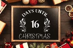 a sign that says days until christmas surrounded by presents and other holiday items on a wooden table