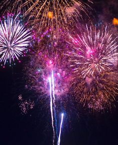 fireworks are lit up in the night sky with bright colors and sparkles on them