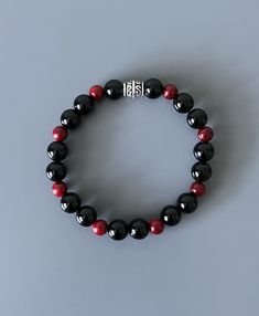 This beaded bracelet features black onyx and red painted quartz round beads. This is unique and one of a kind; you won't see others wearing this! Onyx beads are 8 mm and quartz beads are 6mm. Beads are strung on a thick, durable elastic. Elastic tie is hidden with a silver plated spacer bead. This is a bracelet that can be worn everyday or for a special occasion. Beads are a smooth, glossy finish, which makes it comfortable on the wrist. It's also great as a wearable fidget!  Bracelet will come Wearable Fidget, Fidget Bracelet, Keep Bracelet, Red Accessories, Red Bracelets, Jewelry Black, Onyx Bracelet, Quartz Beads, Onyx Bead