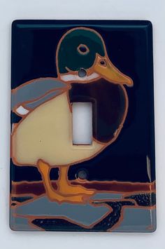 a single light switch cover with a duck on it's side and a black background