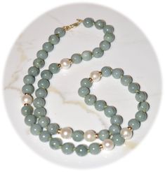 "D E T A I L S (ready to ship) △ Handmade in Canada △ Gemstone Type:     Natural Burma Jade Beads  △ Gemstone Quality: AAA (100% Real Genuine Green Jade Gemstone) △ Gemstone Size:      8.0 mm △ Gemstone Shape:  Round △ Pearl Type:               Extra Shiny Natural White FW Pearls (Genuine) △ Pearl Size:                8mm Round Natural Pearl △ Pearl Shape:            Round △ Pearl Quality:          AAA △ Gold Clasp:             14k Solid Yellow Gold Lobster Claw Clasp and Spacer Beads △ Necklace Length:   21\" including clasp (approximately)   Timelessly elegant jade beaded necklace and 14k solid gold clasp and spacer beads, strung with stretched griffin silk in a matching color.   100% Natural Burma Jade not treated in any way. It is hard to photograph the rich green color in these beads. Crystal Bracelets Diy, Jade Bead Necklace, Jewelry Classic, Jade Gemstone, Solid Gold Necklace, Bracelets Diy, Hippie Necklace, Jade Necklace, Natural Pearl