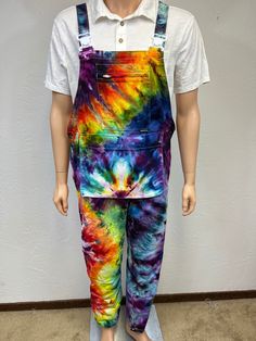 Ice tie dye medium men's overalls. These overalls have 8 pockets! 1 zipped chest, 2 side hand pockets, 1 center front, a large multi-storage pocket, 2 knee pad and a rear pocket. The straps have elastic on back and offers adjustability for a comfortable fit. Heavy cotton.  Made from 100% cotton, is machine wash cold with dark colors, machine dry low. Fun front pocket hangs at the waist, more of a pouch! 2 buttons on both sides of hips, open for easy on and off, also has a zipped fly in front, straps have a plastic easy open button. Can roll up if too long in length. Festival wear for sure! One of a kind, all hand dyed by me! Measurements are garment laid out flat  18 inches from edge to edge at waist top of buttons 20 inches at hips edge to edge 22 inches from top of bib down front to crot Cotton Bottoms With Side Pockets And Bib Front, Cotton Utility Overalls, Utility Cotton Overalls Pants, Cotton Pre-washed Overalls, Acid Wash Cotton Overalls With Pockets, Cotton Overalls With Pockets For Festival, Multicolor Cotton Overalls For Festival, Festival Multicolor Cotton Overalls, Painter Overalls