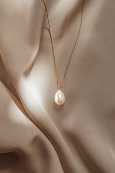 The Giulia Pearl Necklace is handcrafted with a freshwater pearl drop and 14k gold filled box chain. Pair with the Giulia earrings for a perfect match.  Packaged in an elegant plastic-free reusable jewelry box, they make the perfect gift or special treat for oneself. *14k gold-filled chain and components *Freshwater pearl *Hypoallergenic, suitable for even the most sensitive skin *Delivered in a 100% silk jewelry pouchette inside a gift box *Sustainable magnetic closure jewelry box and customiza 14k Gold-filled Teardrop Pearl Chain Jewelry, Feminine Hypoallergenic Gold Jewelry, Hypoallergenic Feminine Gold Jewelry, Elegant Teardrop Drop Necklace With Pearl Charm, Gold Plated Drop Jewelry With Pearl Charm, Timeless Teardrop Necklace For Gift, Feminine Formal Jewelry With Pearl Pendant, Gold Hypoallergenic Pear-shaped Jewelry, Formal Feminine Jewelry With Pearl Pendant