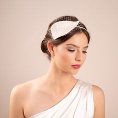 The larger leaf is made of quality millinery fur felt and adorned  with a veiling. Attached to a silk wrapped headband.   This millinery headpiece is versatile enough to complement various bridal styles, whether the bride opts for a vintage-inspired look or a modern, minimalist aesthetic. Colour: pictured in off white Wedding Veil Accessories, Silk Wrap, Minimalist Aesthetic, Wedding Veils, Veil, Fascinator, Bridal Style, Headpiece, Vintage Inspired