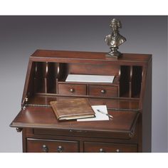 a wooden desk with drawers and a book