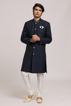 Navy blue sherwani with sequin embroidered butti motifs. Comes with churidar.
Components: 2
Pattern: Embroidered
Type Of Work: Sequin
Neckline: Mandarin Collar
Sleeve Type: Full
Fabric: Sherwani: Computer Embroidery Jacquard, Churidar: Silk Dupion
Color: Blue
Other Details: 
Embellished buttons
Closure:
Sherwani: Front button
Churidar: Drawstring
Note: Pocket square worn by the model is not for sale
Occasion: Sangeet,Mehendi and Puja - Aza Fashions Blue Sherwani, Computer Embroidery, Churidar, Mandarin Collar, Pocket Square, Aza Fashion, Types Of Sleeves, Collar, Embroidery