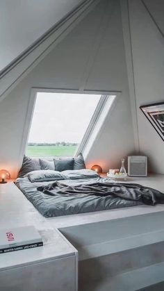 a bed sitting in the middle of a bedroom next to a window