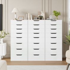 a living room with a white dresser and chair