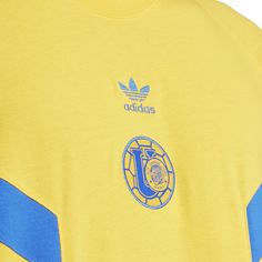 You'll boldly show you're a fan in the adidas Tigres Culturewear Men's Tee. And whether you're chilling with the crew or at home rooting loudly, you'll remain comfortable in this lightweight, relaxed-fit shirt. The short sleeves are perfect for those summer days, but you can even layer it to make your staple fan wear all year.Features: Screen printed graphics. Short-sleeved. Crew neck. Details: Fabric: 100% Cotton. Officially licensed. Casual Crew T-shirt For Fan Gear, Casual Crew Neck T-shirt For Fans, Casual Adidas Tops For Sports Events, Adidas Casual T-shirt For Sports Events, Yellow Adidas Crew Neck Top, Adidas Yellow Crew Neck Top, Yellow Adidas Sporty Top, Adidas Yellow Sporty Top, Sporty Yellow Adidas Tops