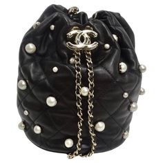 Chanel About Pearls Black Lambskin Drawstring Bucket Bag | From a unique collection of rare vintage Bucket Bags and Drawstring Bags at https://www.1stdibs.com/fashion/handbags-purses-bags/shoulder-bags/bucket-bags-drawstring-bags/. Tas Lv, Tas Hermes, Mode Chanel, Chanel Store, Chanel Mini, Studded Bag, Chanel Shoulder Bag, Drawstring Bucket Bag, Chanel Logo