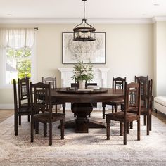 a dining room table and chairs with a rug on the floor