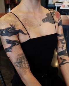 a woman with many tattoos on her arm