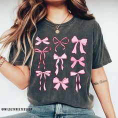 Our pink coquette bows shirt makes the perfect addition to your summer wardrobe.  You will love it! This shirt is made with a professional DTG Printing machine. Printed with eco-friendly water based inks that prints the image/designs on the shirt allowing the image to become part of the shirt so there is no peeling or cracking over time. If you have any questions please feel free to reach out and I will be happy to assist you.  HOW TO ORDER  1. Select the size and color of the shirt you would li Trendy Summer T-shirt With Bow, Trendy Crew Neck T-shirt With Bow, Casual Summer T-shirt With Pink Bow, Cute Bow T-shirt For Spring, Spring Party Tops With Ribbon, Cute Pink T-shirt With Bow, Trendy Spring Tops With Bow Detail, Trendy Spring Tops With Bow, Casual Party Tops With Bow