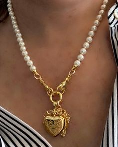 The Ludivine Necklace special keepsake charm necklace. Hand knotted pearl necklace hands holding with our fleur heart locket and Madonna charm.  Pearl shell pearls and gold plated silver charms.  Charms are removable. 19 inches in length. To see more please visit  https://www.etsy.com/shop/BijouLimon Bijou Limon jewelry collections present a romantic French spin on the latest jewelry trends. Based on the US West Coast but French at heart, Bijou Limon interprets the current jewelry trends and del Cottage Core Vintage, Charm Necklace Diy, Pearl Charm Necklace, Latest Jewellery Trends, French Jewelry, Hands Holding, French Wedding, Necklace Pearl, Jewelry Lookbook