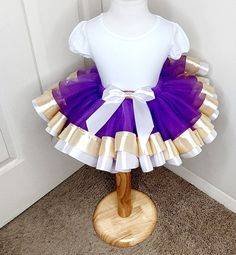 TUTU BIRTHDAY DRESS-Dress for Kids, Baby Girl Tutu Dress, Birthday Party Tutu, Purple And Gold Tutu, Gift for Little Girl This listing is just for the tutu only Tutu sizes are:  6-12 months--16 inch waist 6 inch length 12-18 months--17 inch waist 7 inch length 2T--18 inch waist 8 inch length 3T-4T--19 inch waist 9 inch length 5T-8--20 inch waist 11 inch length Machine Wash Cold & Hang Dry Please allow 10 business days for processing. Then allow another 5-7 days to arrive depending on shipping me Gold Ruffled Dress For Birthday, Gold Fitted Princess Dress For Birthday, Purple Princess Tutu Dress For Baptism, Princess Style White Tutu Dress For First Birthday, White Princess Dress For Birthday, White Fitted Tutu Dress For Birthday, White Ruffles Tutu Dress For First Birthday, White Ruffled Tutu Dress For First Birthday, White Princess Dress With Ruffles For First Birthday