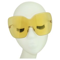 Sporty & chic! Fabulous contemporary Jimmy Choo 'Zelma' wraparound yellow sunglasses designed with a stylistic nod to the mod 1960's. The gold tone frame is light as air and the rimless yellow lenses, with 100% UV protection, are the perfect aid for cutting glare and protecting your pretty peepers. The large size creates a stylized silhouette that will be right at home while poolside or when tooling around town. Fun in the sun! Made in Italy. PLEASE NOTE... These Jimmy Choo's even have a special Wraparound Sunglasses, Vintage Haute Couture, Sunglasses Yellow, Trace Adkins, Yellow Sunglasses, Susan Sarandon, The Mod, Vintage Couture, Couture Vintage