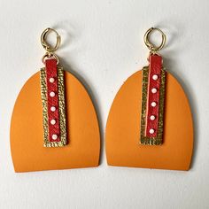 Just imagine... you've spent the day at the beach, the sun's warmed your skin, there's a cool drink in your hand, you're relaxed all the way down to your toes, and the sun is just starting to set at the horizon. These earrings are inspired the splendor of a magical vacation sunset. Two shades of vivacious orange leather, combined with gold leather and 5 hand-sewn sunstone beads, to make these resort-ready earrings. The earrings secure to pierced ears with hinged lever-back ear wires in gold-plat Single Earring For Everyday Summer Wear, Modern Drop Earrings For Summer, Modern Orange Earrings For Everyday Wear, Orange Earrings For Everyday Summer Wear, Summer Teardrop Pierced Earrings, Summer Everyday Earrings With Ear Wire, Everyday Summer Pierced Earrings, Summer Everyday Pierced Earrings, Summer Orange Drop Earrings