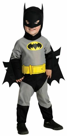 a little boy dressed up in a batman costume with his hands on his hips and mouth open