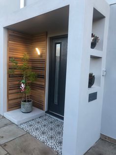 a house with a potted plant in the entry way