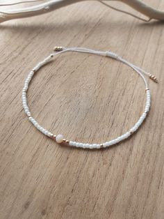 Delicate minimalist string cord bracelet made with creamy and gold toho round beads size 11. Simple, filigree and elegant design at the same time. It can be worn with casual or fancy outfit even for wedding dress The bracelet is adjustable thanks to a macrame slide knot. It is about 15 cm when fully tightened and about 28 cm when expanded. This bracelet is perfect for minimalist jewelry lovers or combine with other bracelets to create a stack!  If you need different size, feel free to ask Thank for visiting my shop! Please contact me if you have any questions!  ~~ Care instructions: To ensure that your piece of jewellery lasts a particularly long time, please avoid excessive contact with water, creams and perfumes and take it off overnight. Delicate Gold Beaded Friendship Bracelets, Elegant Gold Beads Friendship Bracelets As Gift, Elegant Gold Beaded Friendship Bracelets As Gift, Minimalist White Bracelet With Gold Beads, Dainty White Bracelets With Adjustable Length, Dainty White Bracelet With Adjustable Length, White Delicate Adjustable Friendship Bracelets, Delicate White Adjustable Friendship Bracelets, Delicate Adjustable White Friendship Bracelets