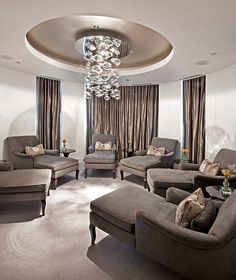 a living room filled with furniture and a chandelier