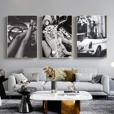 three black and white pictures hang on the wall above a couch in a living room