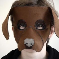 a person with a dog mask on their face and the nose is made out of leather