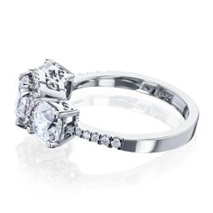 two white gold engagement rings with diamonds on each side and an oval cut diamond in the middle