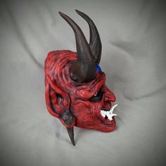 Red Goblin Oni style Noh mask Based off traditional Japanese Noh Masks. Made of PLA and hand painted in acrylics. This mask is large enough to be wearable by most people. Comes as mask only without straps. Inside dimensions are: 240 H x 160 W mm/ 9.5 H x 6.25 W in Overall Dimension: 340 H x 200 W mm/ 13.5 H x 8 W in Each piece is individually made to order so keep in mind: It will possibly take a couple weeks to paint and get it shipped out. The paint and coloring may differ slightly the picture Artistic Red Masks And Prosthetics For Costume, Traditional Red Masks And Prosthetics For Costume, Traditional Red Costume Masks And Prosthetics, Artistic Red Mask For Costume, Traditional Cosplay Masks And Prosthetics, Traditional Cosplay Masks, Handmade Red Masks And Prosthetics For Masquerade, Handmade Red Masquerade Mask, Red Goblin