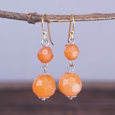 Ghanaian artisan Tina Quaye explores modern trends in this pair of dangle earrings of avant-garde allure. Recycled glass beads in orange hues compose the accessories, whose geometric finish creates a dazzling look. On top of that, brass hooks allow for comfortable and easy wear. Orange Czech Glass Dangle Earrings, Orange Adjustable Beaded Drop Earrings, Adjustable Orange Beaded Drop Earrings, Orange Faceted Beads Dangle Earrings, Orange Drop Earrings With Dangling Beads, Nickel-free Orange Beaded Drop Earrings, Nickel-free Orange Beaded Dangle Earrings, Modern Orange Drop Earrings, Orange Faceted Beads Earrings For Gifts