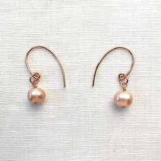 Cultured Freshwater Pearl & 14KT Rose-Gold Filled Earrings; Versatile to wear with a simple chain or a freshwater pearl necklace; Handcrafted in California Freshwater pearls are a light mauve, semi-round shape Earrings are 1" long with fishhook ear wires Each piece is hand-made No exchanges due to sanitary reasons Wear with the Freshwater Pearl & 14KT Rose Gold Necklace Cost-Saving Sparkle Set Bundle: These earrings are also part of the Pearl & Rose Gold Earring and Choker Set. ~ Necklace not in Hypoallergenic Rose Gold Round Pearl Earrings, Delicate Hypoallergenic Rose Gold Pearl Earrings, Hypoallergenic Rose Gold Pearl Earrings, Rose Gold Round Pearl Charm Earrings, Rose Gold Pearl Charm Earrings, Dainty Rose Gold Pearl Earrings For Gift, Rose Gold Pearl Earrings For Gift, Dainty Rose Gold Pearl Earrings As Gift, Rose Gold Pearl Round Earrings