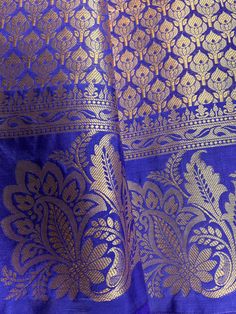 Gorgeous Statement designer Saree in Royal Blue color with Muted Gold Zari Weaving. Saree has Floral Motifs all over with design pattern borders with big flower buttas. Item : SareeColor : Royal Blue Base Fabric : Banarasi Silk Blouse material : Soft Banarasi Silk Work : Handloom Blue Raw Silk Dupatta With Pallu, Blue Chanderi Dupatta For Puja, Royal Blue Saree With Zari Weaving For Diwali, Blue Handloom Lehenga For Traditional Ceremonies, Royal Blue Saree For Puja And Diwali, Royal Blue Saree For Diwali Puja, Blue Art Silk Dupatta With Traditional Patterns, Blue Traditional Wear With Zari Weaving In Raw Silk, Transitional Blue Banarasi Silk Blouse Piece