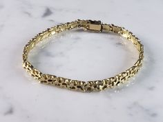 "A WOMEN'S 14k YELLOW GOLD NUGGET BRACELET THAT WEIGHS 12.6g. THE BRACELET MEASURES ABOUT 1/8\" WIDE AND 7\" LONG. BRACELET IS MARKED AND HAS BEEN TESTED. ANY QUESTIONS PLEASE ASK. BE SURE TO CHECK OUT SOME OF MY OTHER GREAT ITEMS UP FOR SALE. THANK YOU." Formal 14k Gold Oyster Bracelet, Vintage Yellow Gold Tarnish-resistant Bracelet, Vintage Tarnish Resistant Yellow Gold Bracelet, Vintage Tarnish-resistant Yellow Gold Bracelet, Luxury Yellow Gold Nugget Jewelry, Gold Diamond Oyster Bracelet For Anniversary, Hallmarked Yellow Gold Bracelet For Anniversary, Gold Diamond Bracelet With Oyster Clasp For Anniversary, Yellow Gold Oyster Bracelet For Anniversary