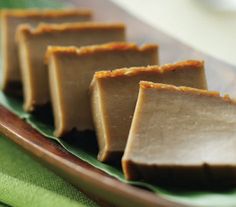 five pieces of chocolate sitting on top of a green plate