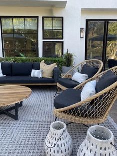 an outdoor living room with wicker furniture